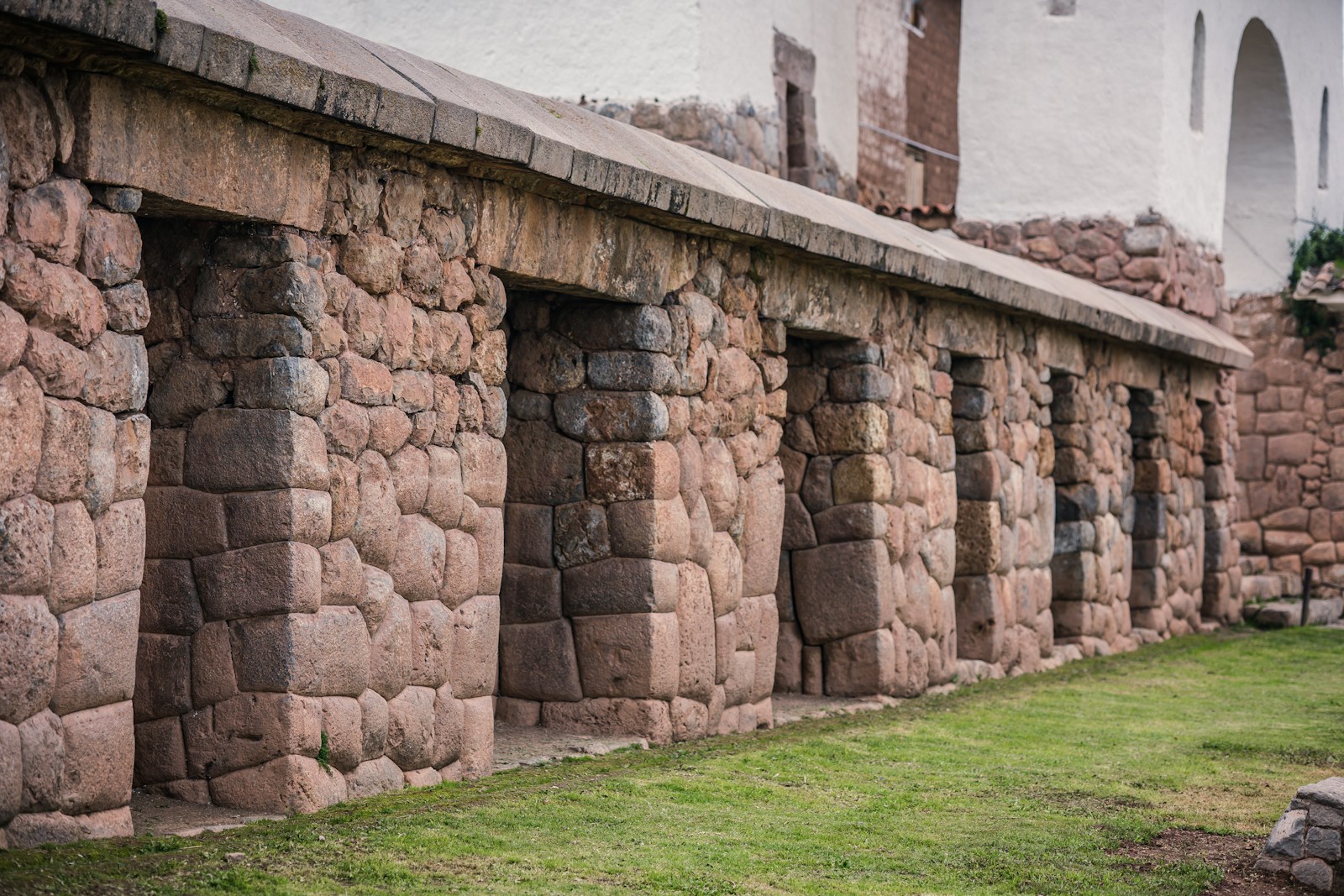 a row of stone walls next to a building